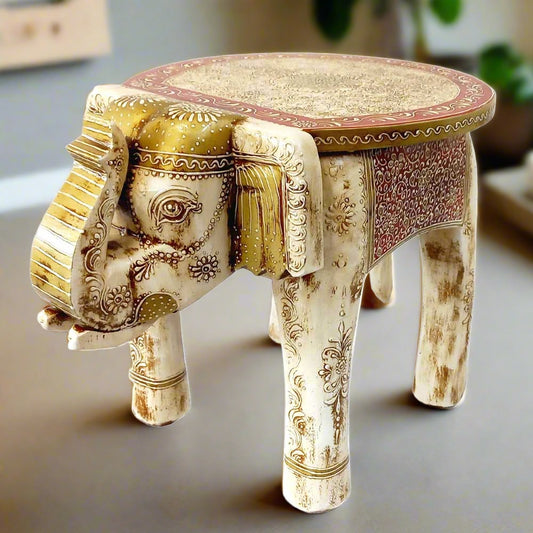A beautiful wooden elephant stool with an antique look and ivory color painting.