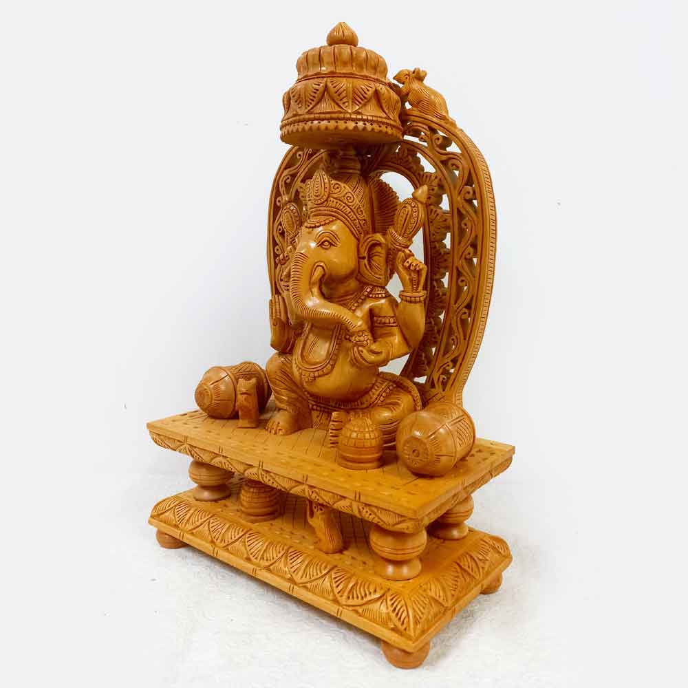 A beautiful wooden Ganesha idol with a mouse and prasad, a great gift for any occasion.