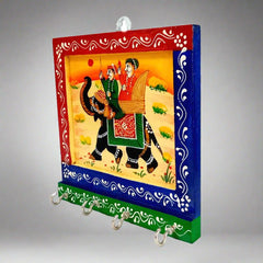 A wooden key holder with 4 hooks, featuring traditional Rajasthani miniature painting.