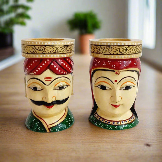 A luxurious wooden pen stand with hand-painted man and woman faces, a traditional art of Rajasthan.