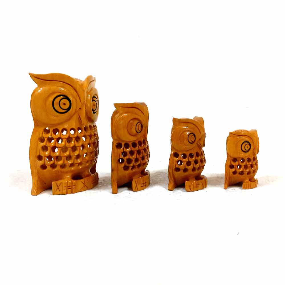 Elegant wooden owl statues made from kadam wood with black eyes and intricate mesh work for home decoration.