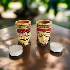 Handcrafted wooden tea light candle holder decorated with detailed hand painting of a man and woman.