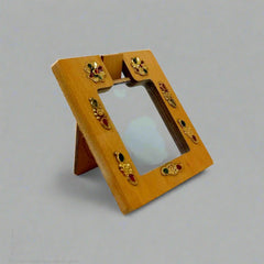 A wooden travel mirror with a beautiful design, an ideal gift for women.