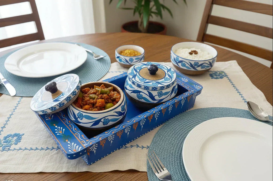 Lifestyle shot of a royal Jaipur wooden tray set with dry fruits on a decorated dining table.