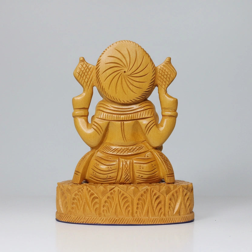 Bottom back view of the 10cm wide rectangular base of a solid wood Ganesha, showing the stable construction.