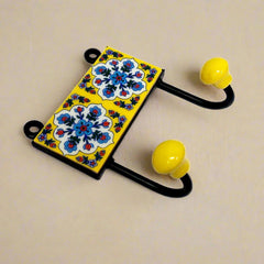A two-hook Blue Pottery wall art piece, perfect for hanging towels in a bathroom.