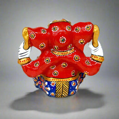 Colorful metal Ganesha statue with intricate meenakari artwork