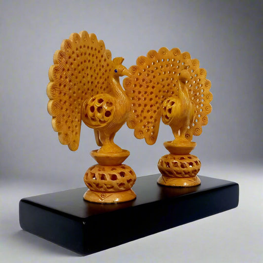 Intricately carved double peacock showpiece with colorful detailing on wooden base