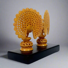 Decorative dancing peacock statue with vibrant colors and undercut carving design