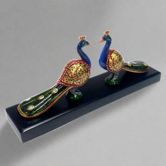 Colorful long tail peacock figurines mounted on wooden base