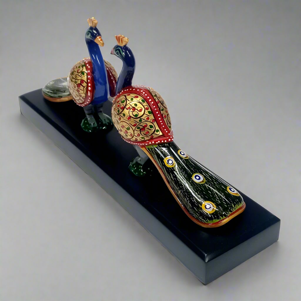 Intricately detailed wooden decor of two peacocks with extended tails