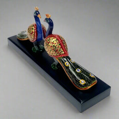 Intricately detailed wooden decor of two peacocks with extended tails