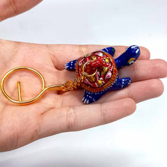 Elegant tortoise-shaped keychain with vibrant Meenakari painting