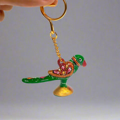 Hand-painted Meenakari parrot keychain with vibrant enamel detailing.