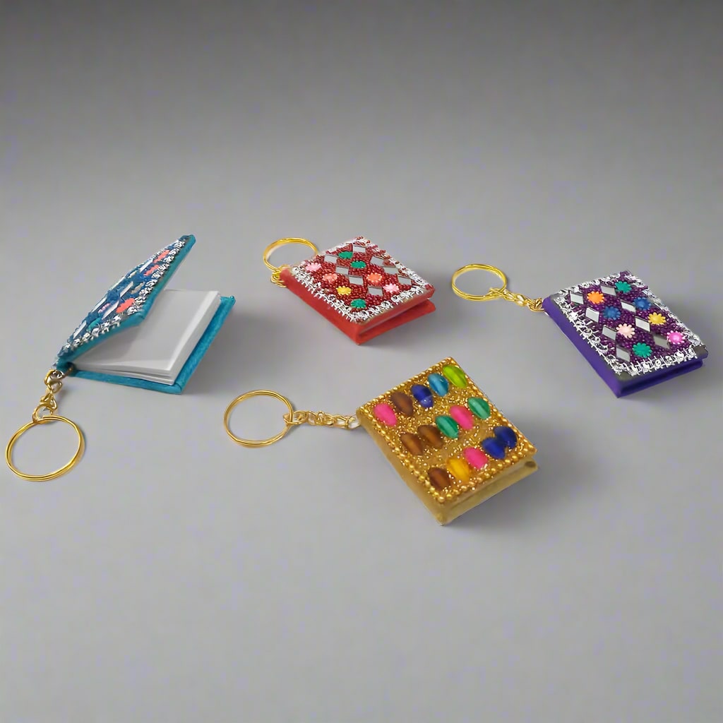 Handcrafted diary-shaped keyring made from lac with mirrors and beads.