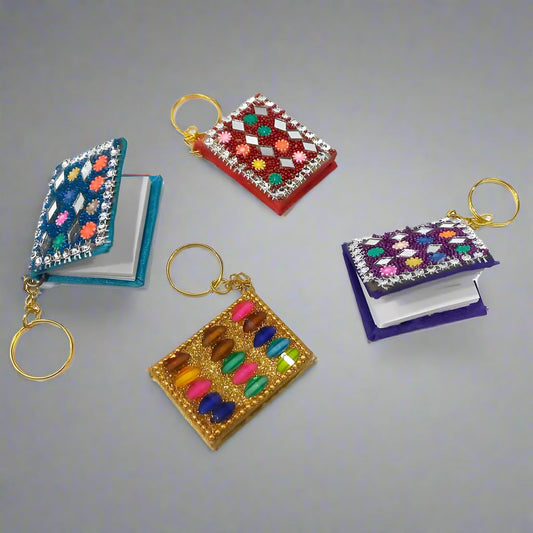 Unique diary design keychain featuring colorful beads and mirror work.