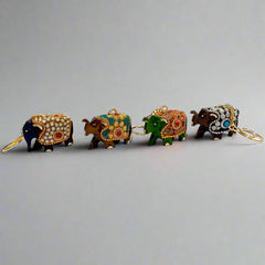 Artistic wooden keychain featuring elephant design with intricate beadwork.