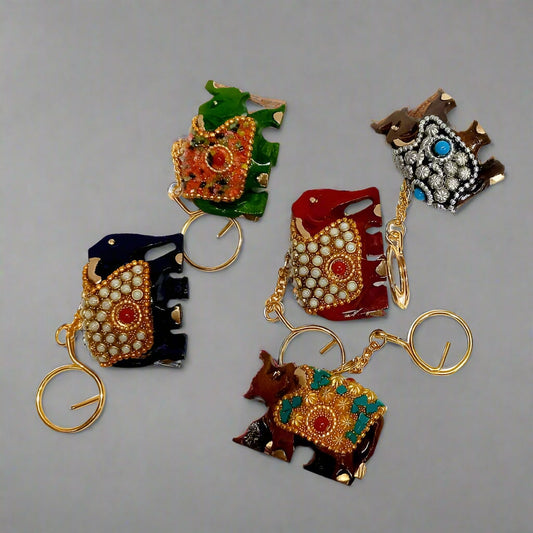 Handcrafted wooden elephant keychain decorated with stones and beads.