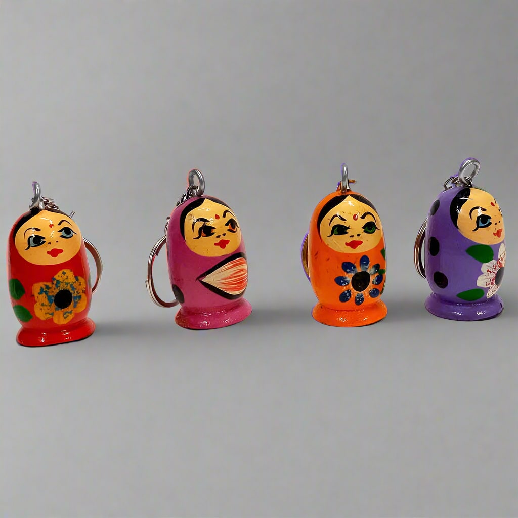 Handcrafted wooden doll keychain with colorful hand-painted design.
