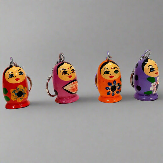Handcrafted wooden doll keychain with colorful hand-painted design.