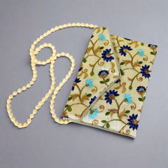 Decorative clutch bag with exquisite zari and embroidery patterns, ideal for festive occasions