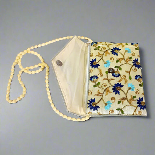 Beautifully crafted polyester clutch featuring traditional zari and embroidery work in vibrant colors