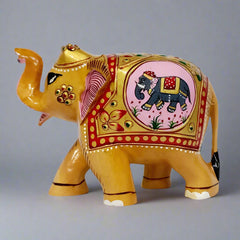 Kadamb wood carved elephant with detailed embossed artwork and trunk raised symbolizing good luck and prosperity, measuring 10cm tall.