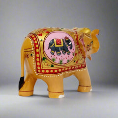 Decorative wooden elephant statue with hand-painted embossed designs and a small painted elephant motif on its body, showcasing traditional craftsmanship.
