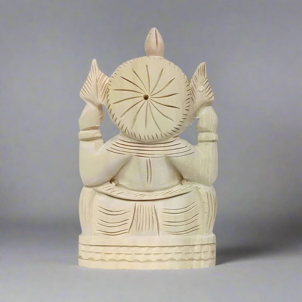 Intricately crafted Ganesh figure made from shriparni wood, showcasing natural wood grain and artisan skill