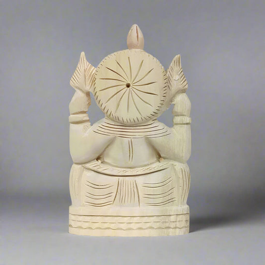 Intricately crafted Ganesh figure made from shriparni wood, showcasing natural wood grain and artisan skill