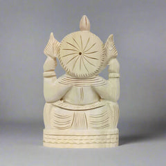 Intricately crafted Ganesh figure made from shriparni wood, showcasing natural wood grain and artisan skill