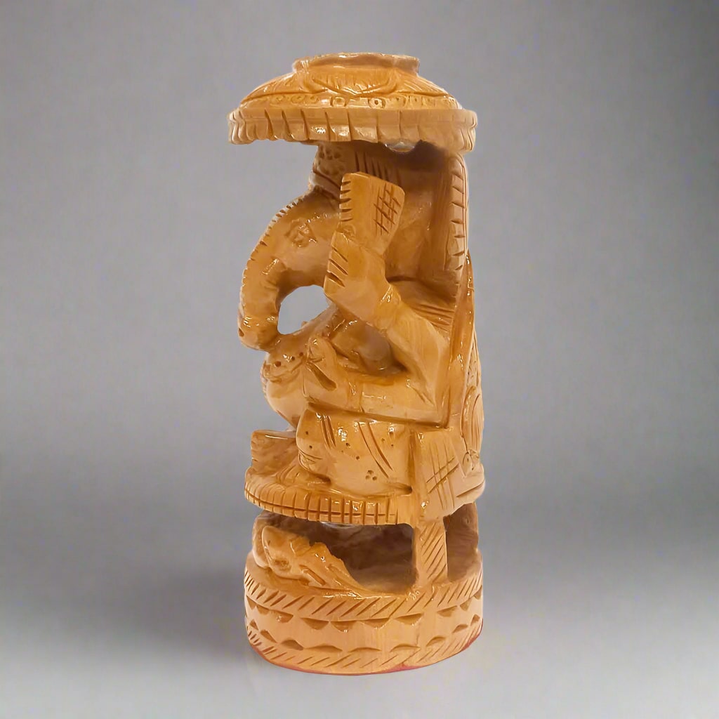 Wooden Ganesh statue with fine carving and umbrella, ideal for home altar and spiritual spaces