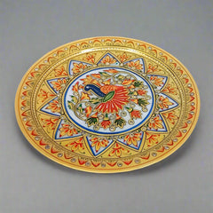 Luxurious marble plate adorned with detailed peacock painting and raised floral motifs, blending traditional craftsmanship with sophisticated design.