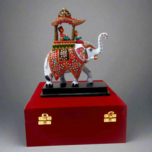 Colorful Meenakari-painted elephant figurine with royal design and intricate craftsmanship, packed in a velvet gift box.