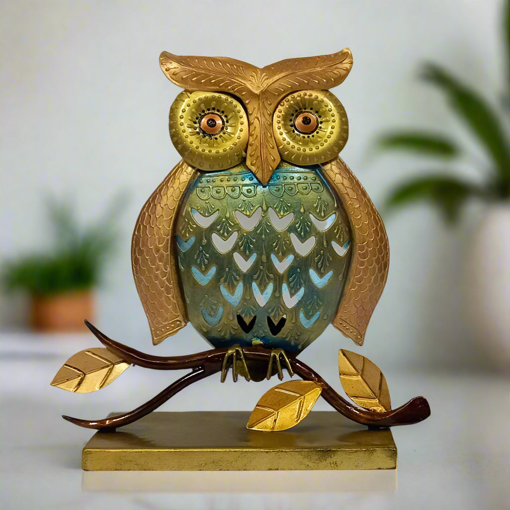 Decorative owl-shaped candle holder in gold, copper, and blue finish.