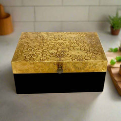 Showcasing fine craftsmanship, this antique-style wooden box has detailed brass work on the top, making it a stylish and functional accent piece.