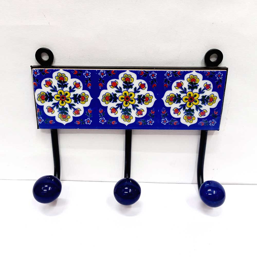 A 3-hook Blue Pottery wall art piece, perfect for hanging towels in a bathroom or entryway.