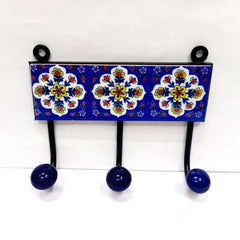 A 3-hook Blue Pottery wall art piece, perfect for hanging towels in a bathroom or entryway.