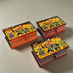 A group of 6x4 inch wooden jewelry boxes in assorted vibrant colors with hand-painted details.