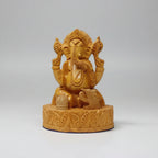 Side view highlighting the 8cm depth and thickness of the 13cm tall hand-carved wooden Ganesha.