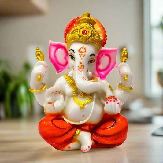 Elegant white resin Ganesha statue with golden crown and ornaments, symbolizing peace, wisdom, and prosperity.
