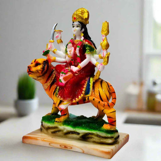 Divine statue of Maa Durga astride her lion mount, symbolizing strength and victory over evil, crafted from resin.