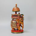 16cm hand-painted wooden Ambabari elephant featuring gold-toned pigments and a carved umbrella.