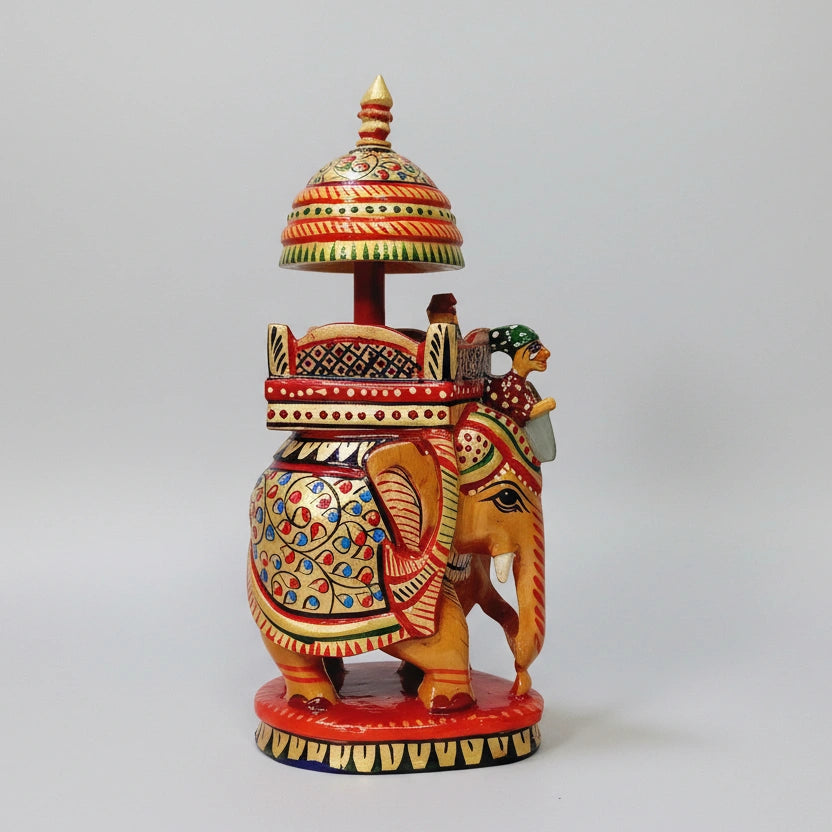 16cm hand-painted wooden Ambabari elephant featuring gold-toned pigments and a carved umbrella.