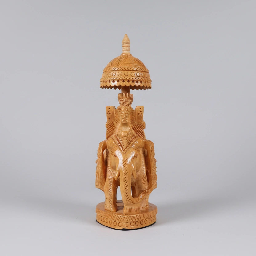 Close-up of the intricate howdah design and masterful carvings on a wooden elephant.