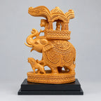 Wooden Ambabari elephant with floral carvings, a raised trunk, an ornate canopy and a small lion figure on a black display base.