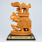 Carved wooden Ambabari elephant with an ornate canopy on a black base displaying a sample company name and logos.