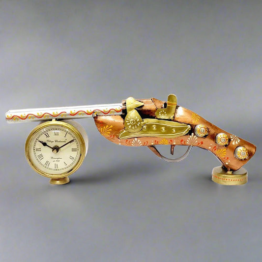 An antique gun-shaped metal table clock with a wonderful ancient look.