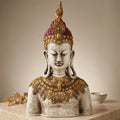 Front view of antique-look resin Buddha bust with an ivory-tone face, maroon headpiece and ornate gold-tone collar