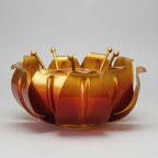 Close-up of the central glass holder inside the metal lotus petal design.